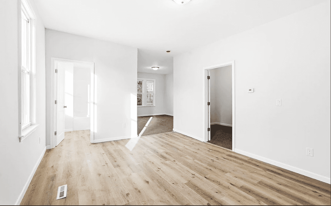 Newly renovated main room with bright natural light and hardwood floor